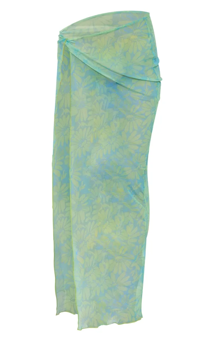 Jupe mi-longue en mesh transparent bleu imprimé torsadée devant